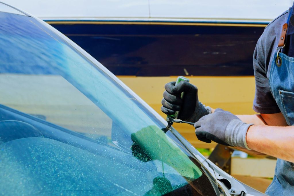 Expert applying resin to fix a windshield for Mobile Windshield Repair Baltimore, providing convenient auto glass repair.