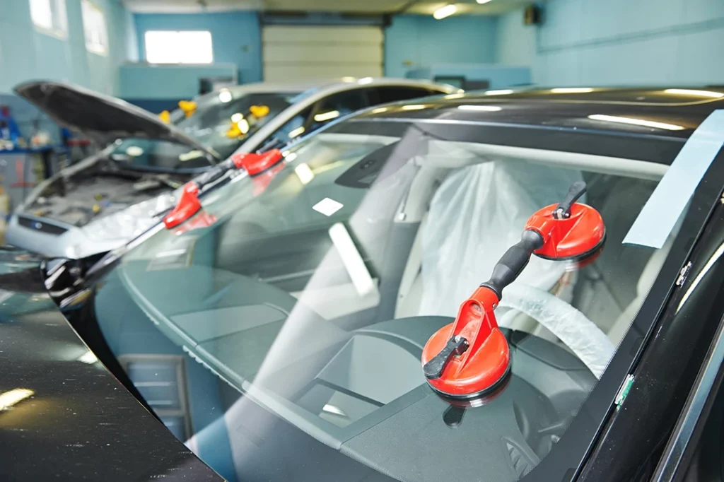 Car Windshield Fix Windsor Mill Manor - two cars in a garage receiving windshield replacement