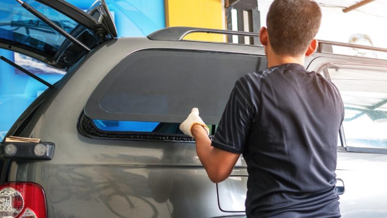 Tinted window installation on SUV—explore expert auto glass replacement Baltimore for repairs and customization.