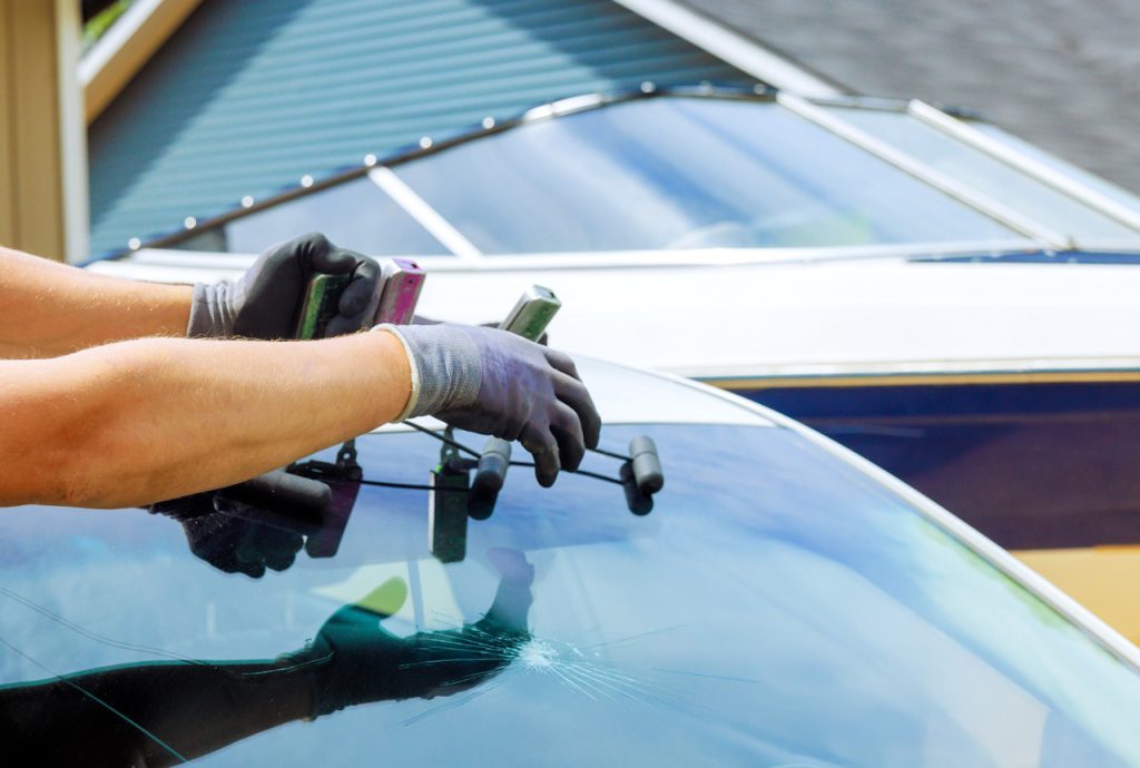 Close-up of a cracked car windshield being prepped for repair by a specialist offering mobile windshield repair service Baltimore.