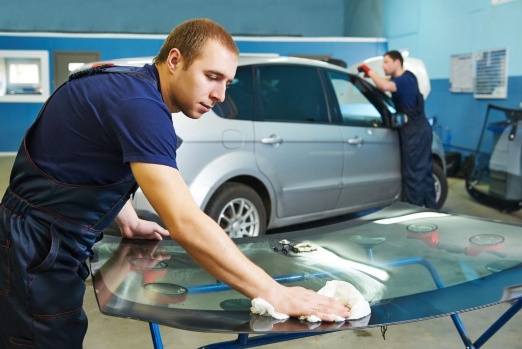 Technician thoroughly cleans a new windshield for professional glass car repair Baltimore and installation.