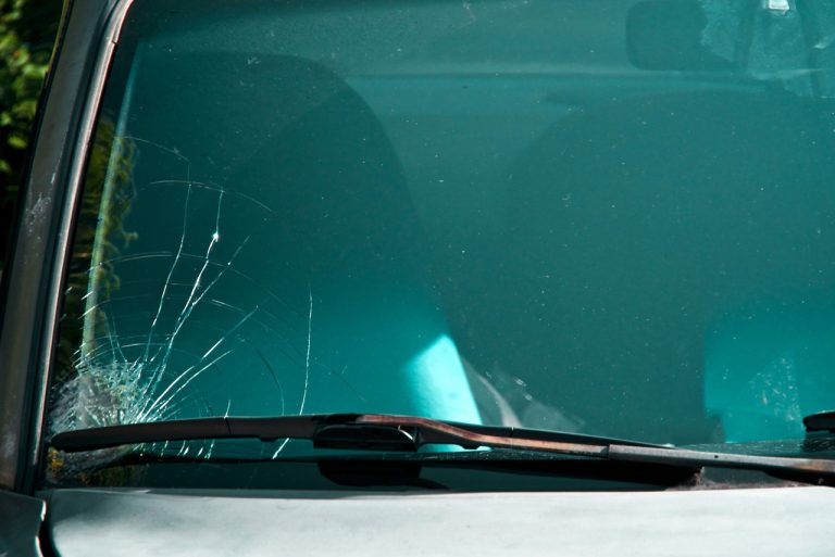 Detailed view of a deep driver side windshield crack that needs immediate auto glass replacement Baltimore repairs.
