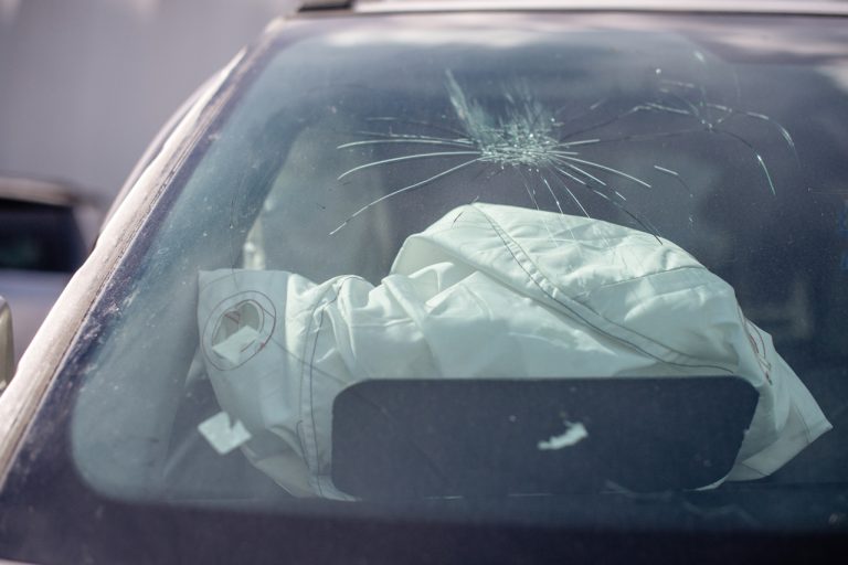 Cracked windshield and deployed airbag after accident. Expert windshield repair shop Baltimore for fast service.