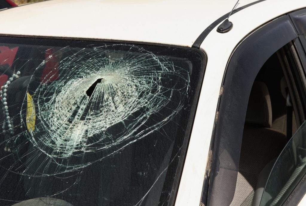 Severe damage and hole in car windshield glass. Schedule trusted windshield repair shop Baltimore service now.