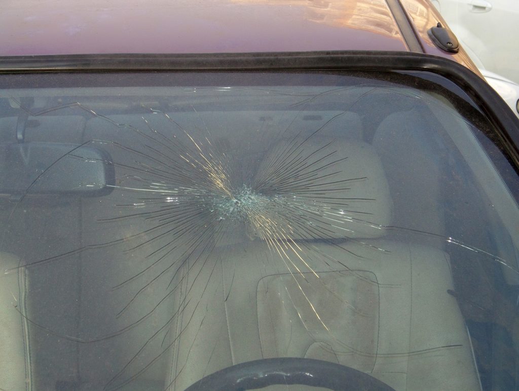 Starburst pattern cracked car windshield needs immediate replacement. Visit the best windshield repair shop Baltimore.
