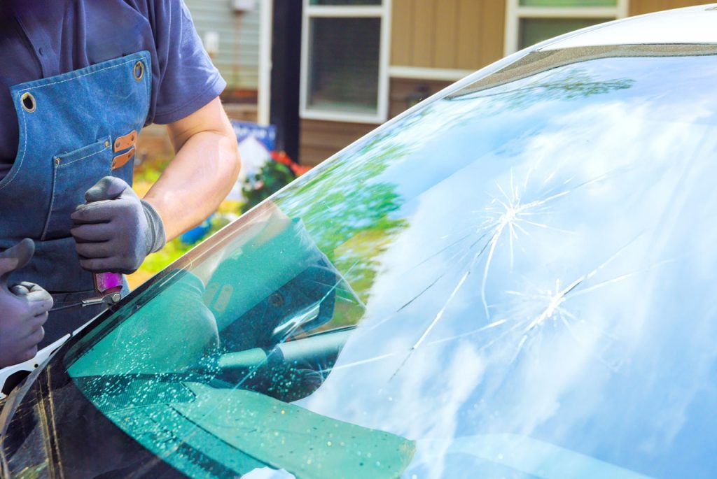 Professional technician at an auto glass company Baltimore performing a precise windshield crack repair service.