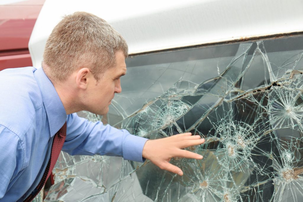 Professional technician evaluating a spiderweb crack for a windshield repair Baltimore service appointment.