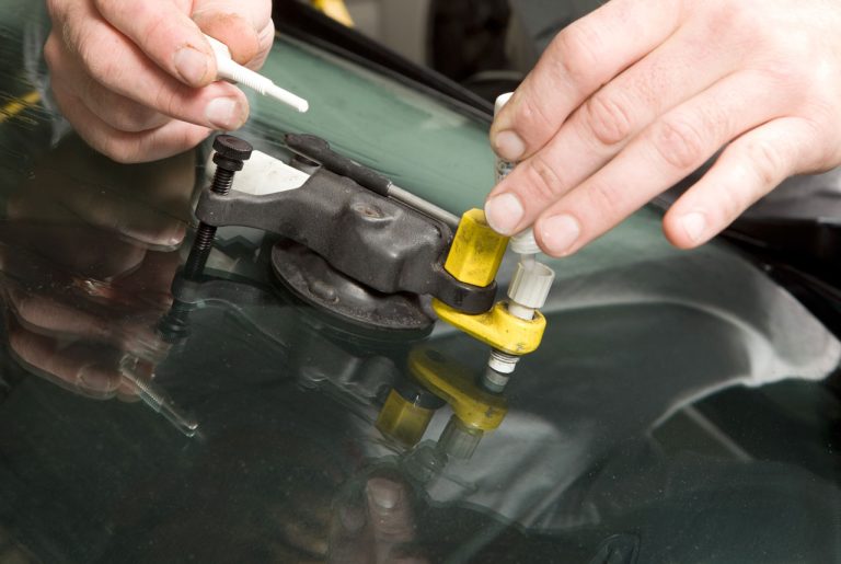Windshield chip repair kit being used for auto glass repair