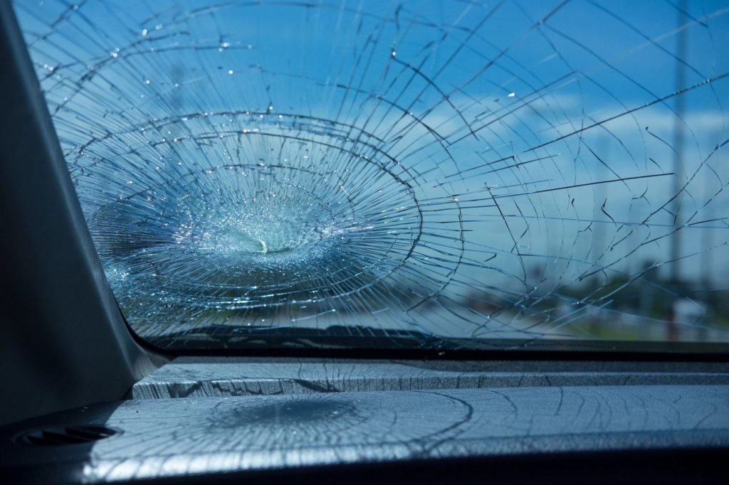 Interior view of a severely shattered windshield requiring an urgent auto glass repair service Baltimore for replacement.