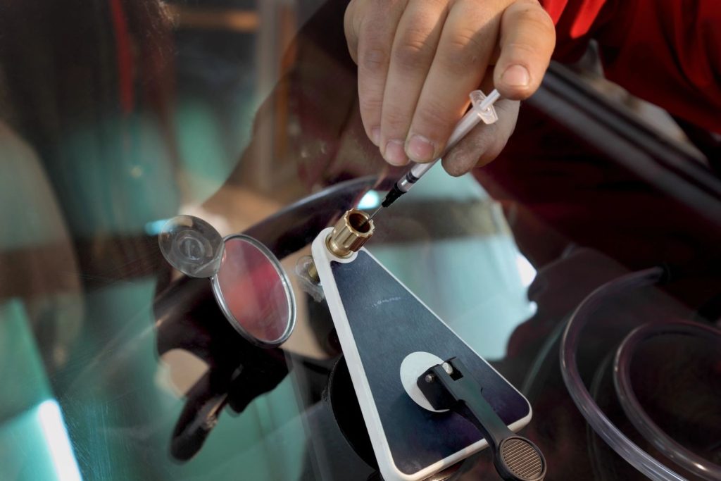 Precise resin injection for a windshield chip repair by a specialist at a top-rated auto glass shop Baltimore.