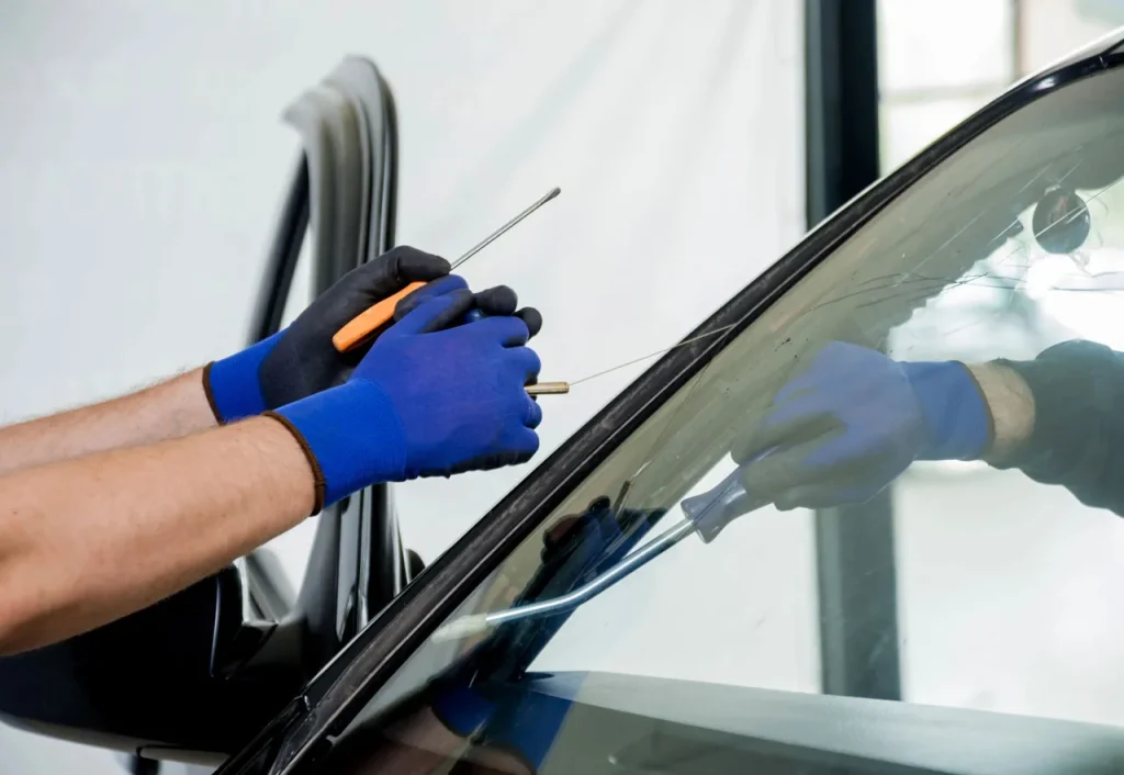Expert technician using specialized tools for a precise windshield fix Baltimore crack repair on a passenger vehicle