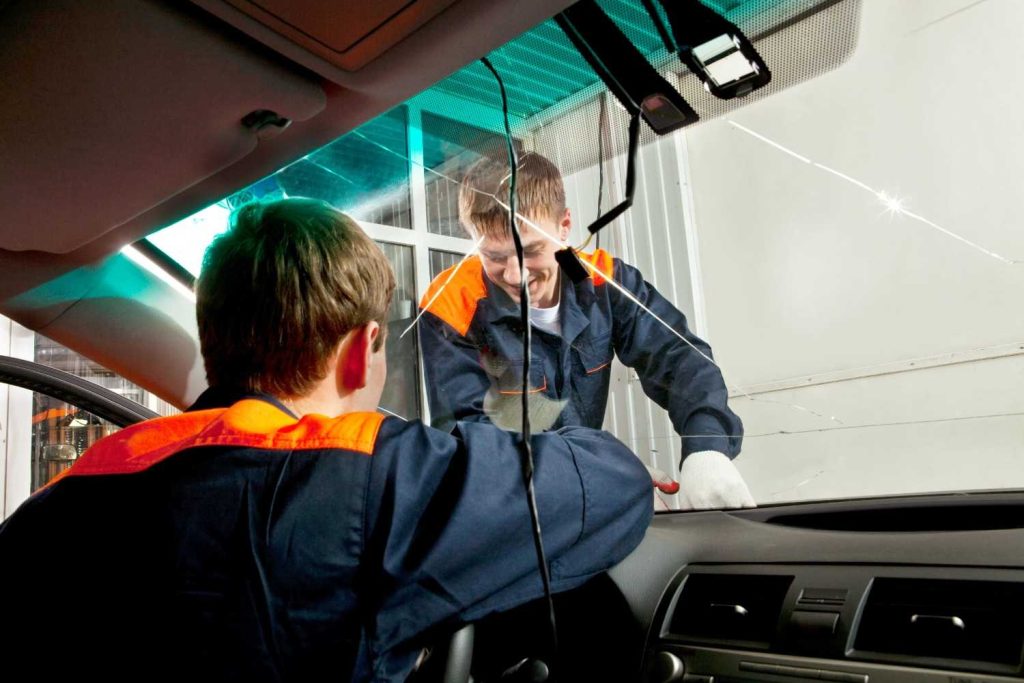 Professional team performing auto glass replacement and repair Baltimore for a severely cracked windshield.