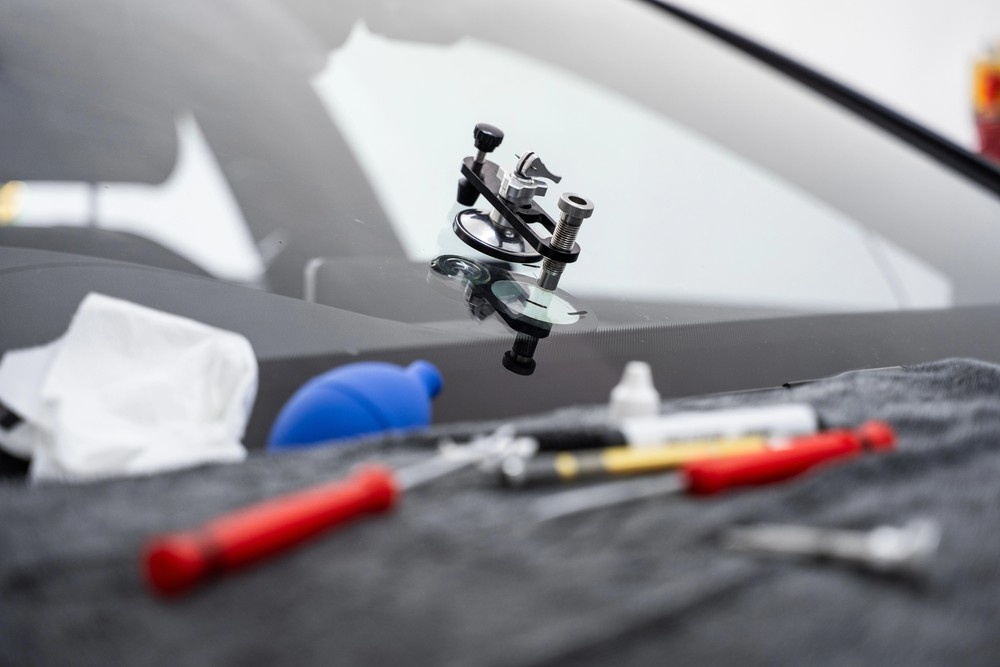 A specialized windshield chip repair bridge is affixed to a star crack. Our toolkit includes everything for a reliable Auto glass fix baltimore.