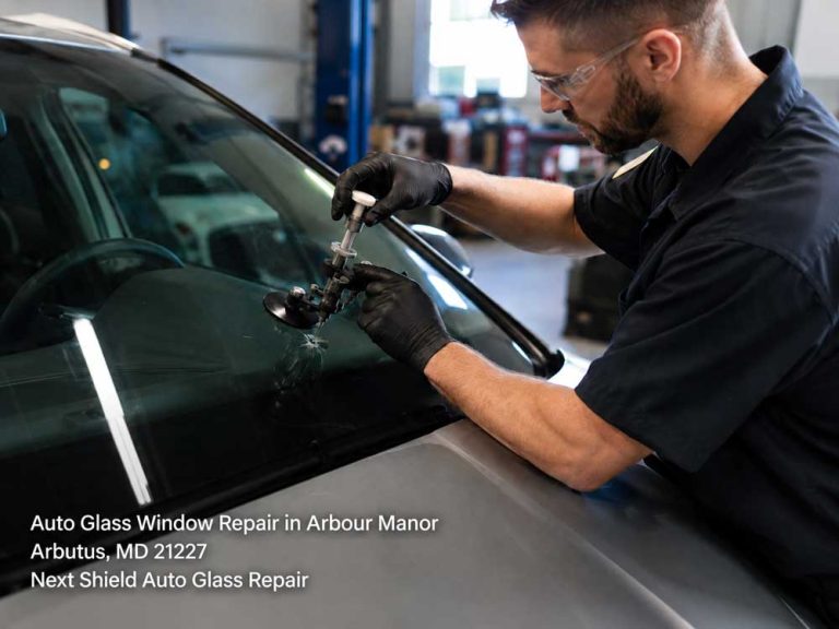 Professional mechanic fixes a bullseye crack during an auto glass window repair Baltimore vehicle service.